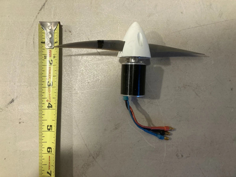 RC brushless outrunner motor with propeller, attached wiring and black cylinder body