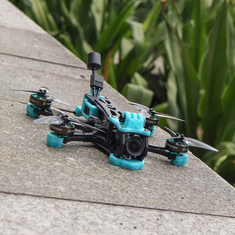 Foxeer Mega DC 4-inch freestyle FPV quadcopter drone with teal frame and black props