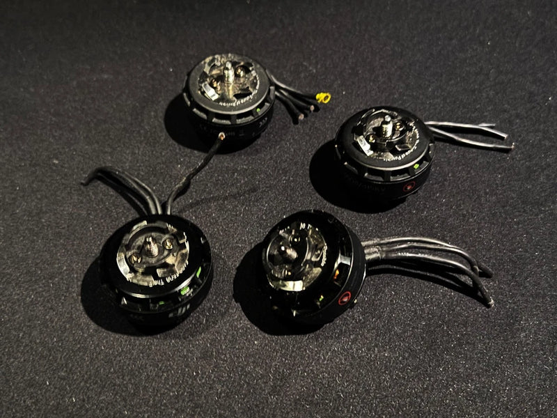 DJI 415kv brushless motor set with four black motors and attached wire leads