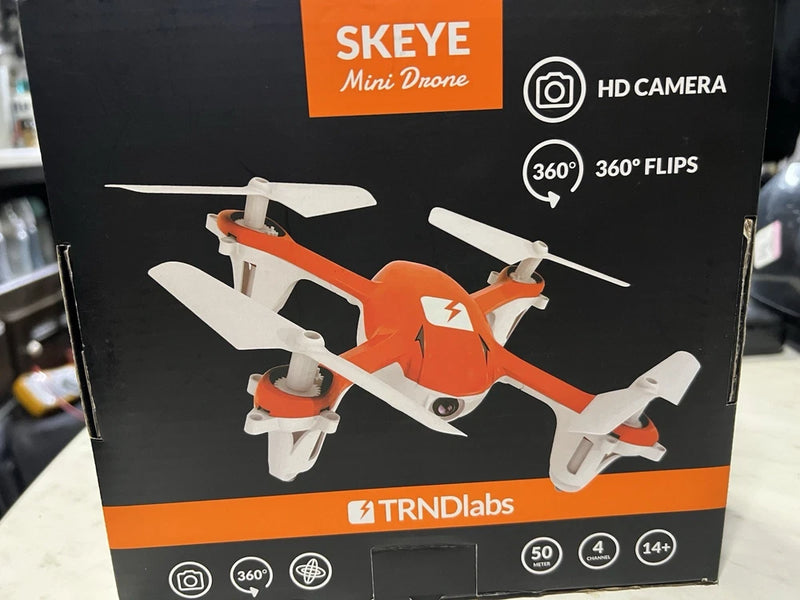 Orange and white mini quadcopter drone with HD camera, shown on retail box
