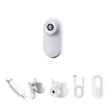 White thumb action camera with USB plug, mounting clips, and cable accessories
