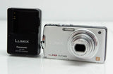 Silver Panasonic LUMIX compact digital camera with front lens and open LCD screen