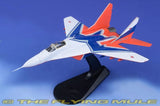 1:72 MiG-29 model aircraft with blue, white, and orange paint on black display stand