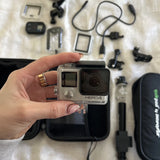 Gopro HERO4 action camera in waterproof housing, front lens and screen visible