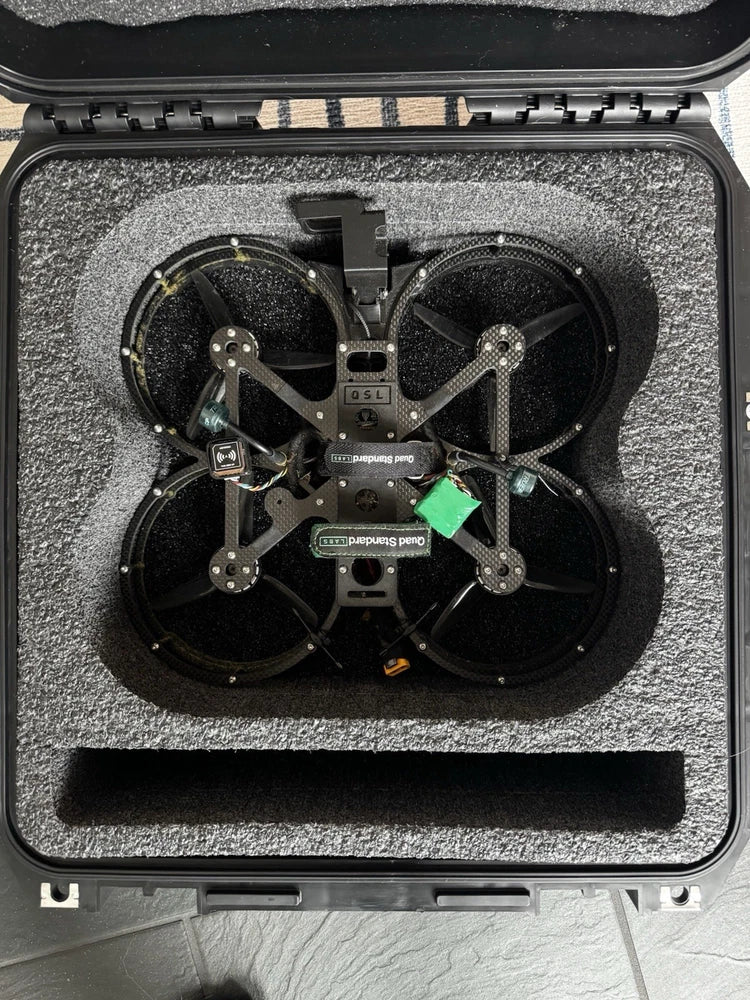 FPV drone with four propellers, inside hard case with foam lining