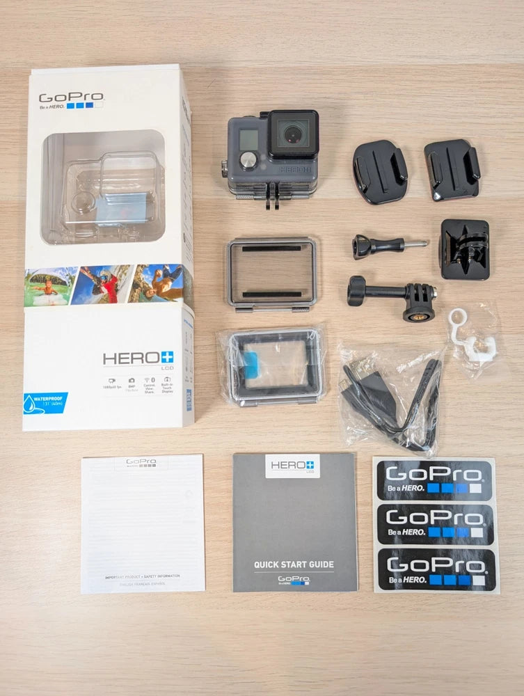 GoPro HERO+ action camera with touch display and mount accessories, shown with packaging