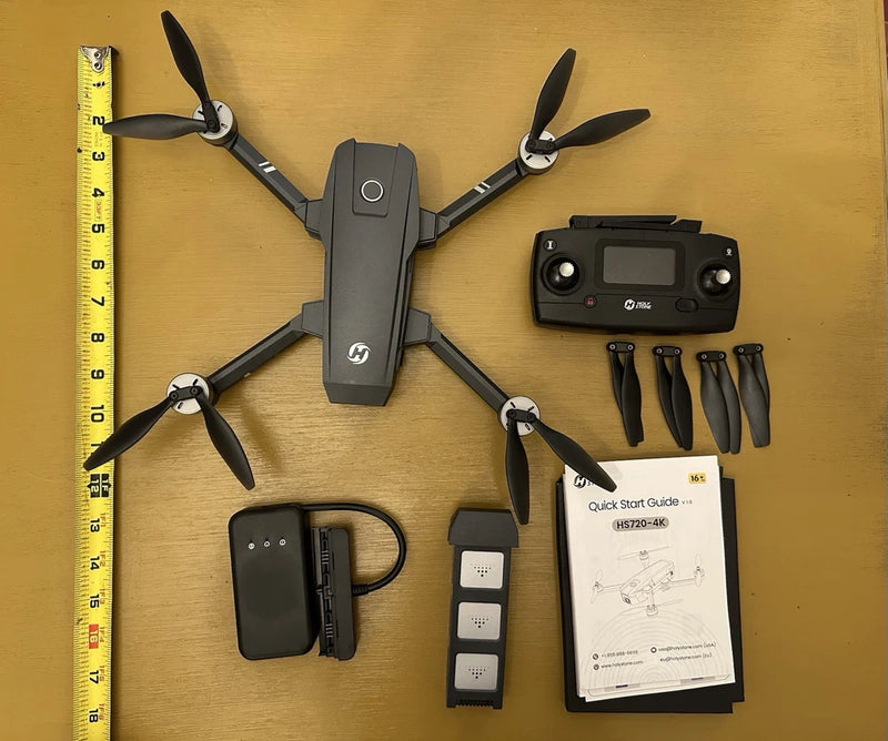 Holy Stone HS720 quadcopter drone with controller, battery, and instruction manual