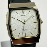 Tungsten analog wristwatch with octagonal case, gold dial markers, and black strap