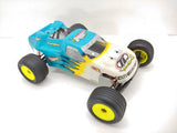 Blue and white 1/10 RC stadium truck roller with black tires and yellow rims