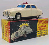 Cream vintage ambulance toy car with roof light, shown with Lincoln Jaguar box