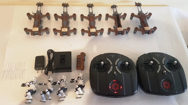 RC speeder bike set with two black remote controllers, charger, and small mini units