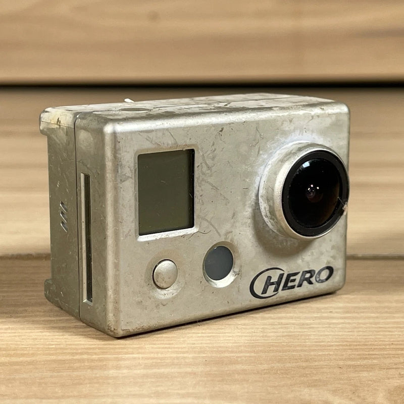 Silver GoPro Hero action camera front view with lens, small screen, and buttons