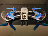 Lowrider freestyle quadcopter drone with blue propellers and front camera pod