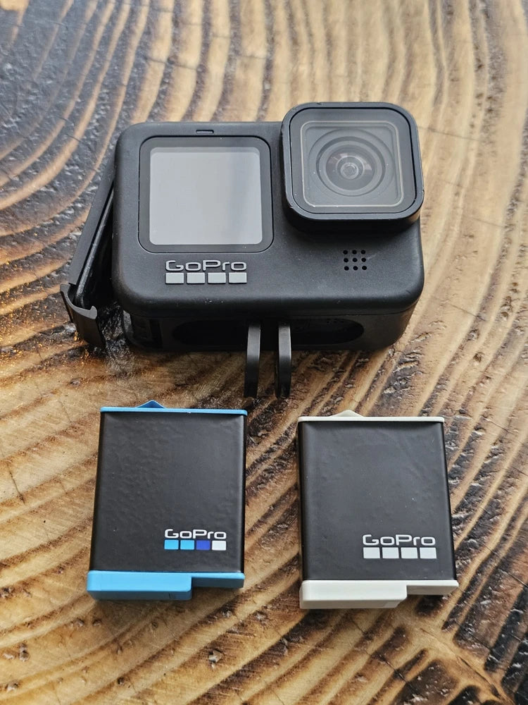 GoPro HERO9 Black action camera with front screen, lens, and two GoPro batteries