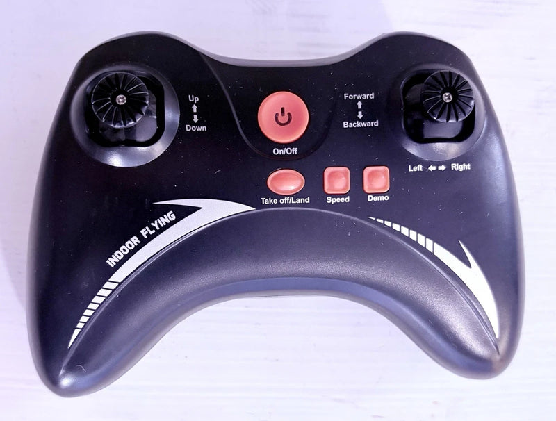Black handheld remote controller with dual thumb dials and buttons, power and speed controls