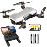 White quadcopter drone with 4K Ultra HD camera, plus black remote controller and phone mount