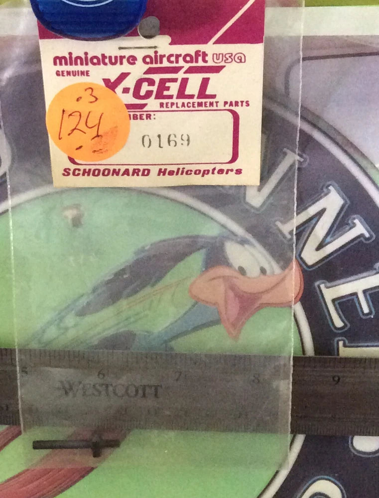 RC helicopter replacement parts in package, showing a green circular piece and metal pin