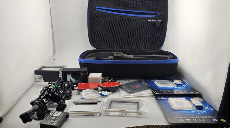 GoPro action camera bundle in open zip case with mounts, battery, and accessories