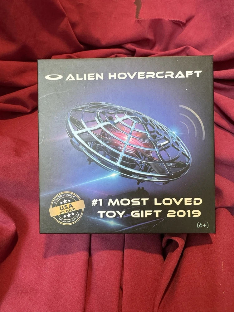Interactive hovercraft drone packaging with purple-lit flying saucer graphic