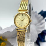 Gold-tone women's dress watch with round white dial and mesh link bracelet