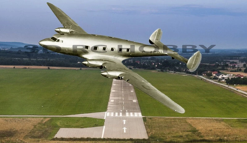 RC balsa wood airplane model with olive-green fuselage and four-window nose