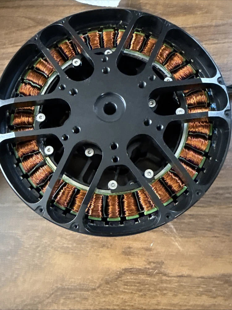 Brushless drone motor stator, circular black housing with copper windings