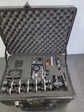 Hard-shell camera case open with action camera and mounted accessories