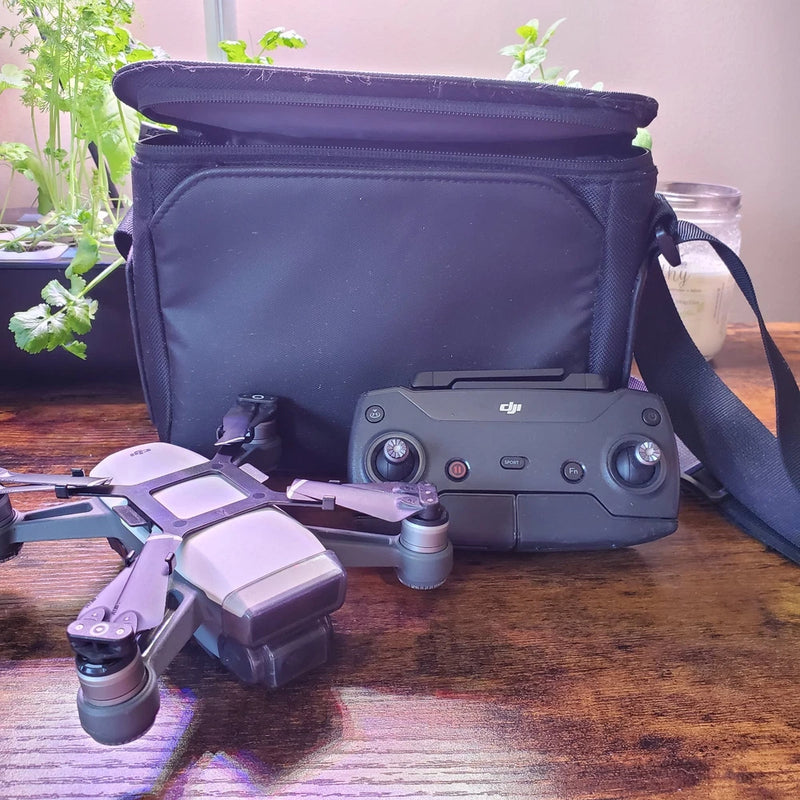 DJI Spark drone kit with controller and dark blue carrying case