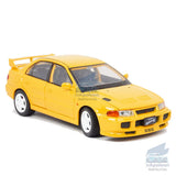 Yellow 1:32 diecast model car, front three-quarter view with headlights and grille