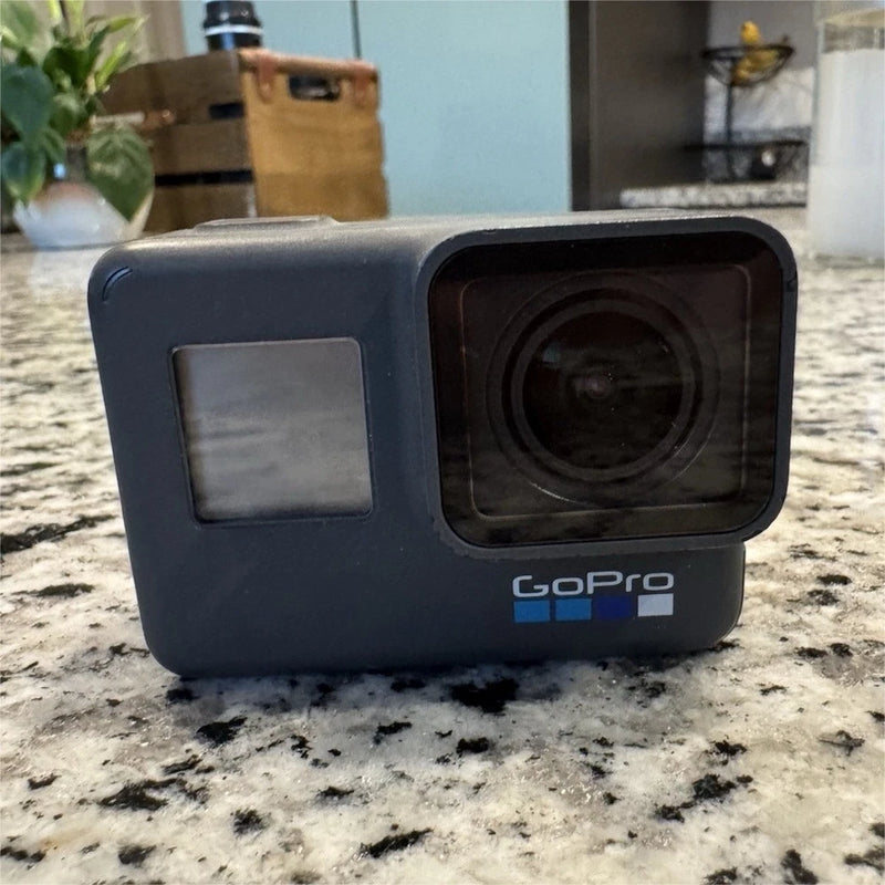 GoPro Hero 6 action camera in dark housing, front touchscreen and lens window visible.