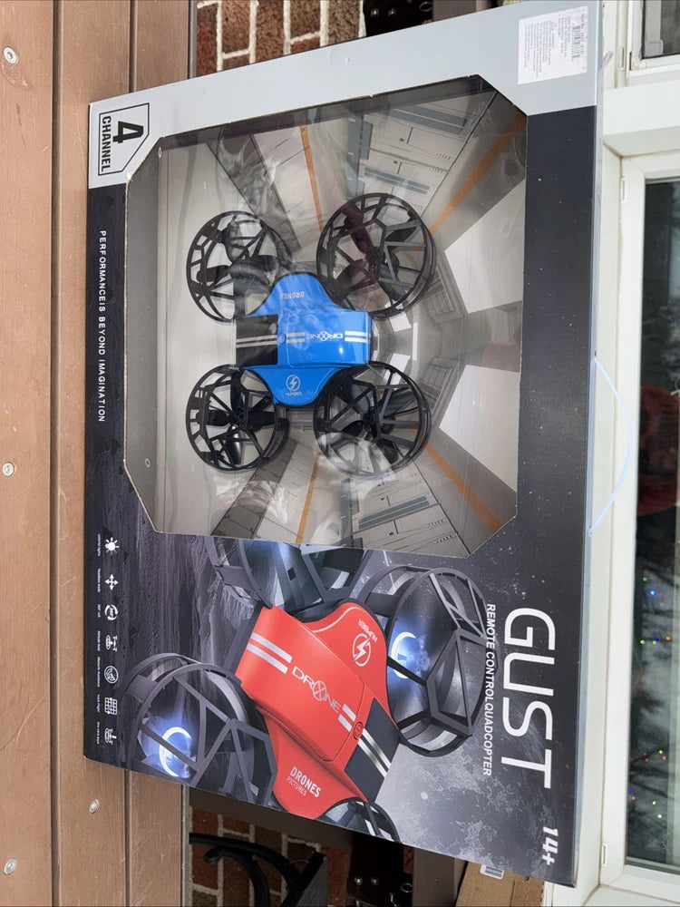 Quadcopter drone set in retail box with red handheld controller and blue lights