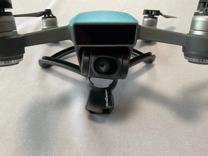 DJI Spark drone with front camera gimbal and blue body, four propellers visible