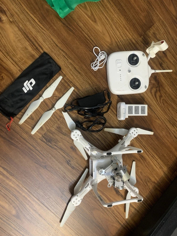 DJI drone kit with remote controller, battery, and four propellers