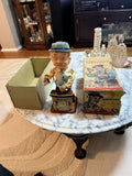 Vintage battery-powered bartender toy figurine with hat and glasses, holding a cup.