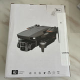 4K camera drone, gray quadcopter with front camera and folded propellers in box