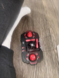 Mini drone with red LED lights and black body, compact handheld size