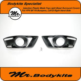 Pair of black plastic fog light bezel covers with circular openings, left and right