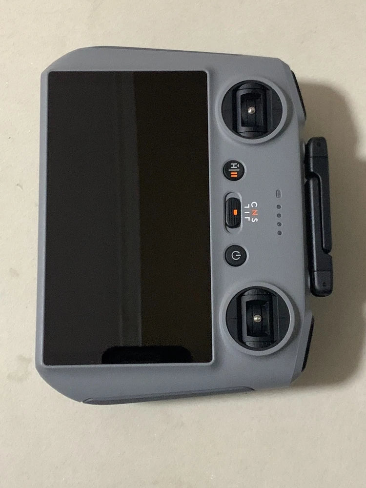 DJI RC2 controller with dark screen, dual top knobs and side handle, gray casing