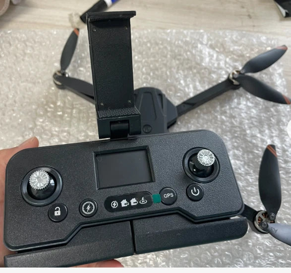 Black handheld drone remote controller with screen mount, buttons, and joystick-like knobs