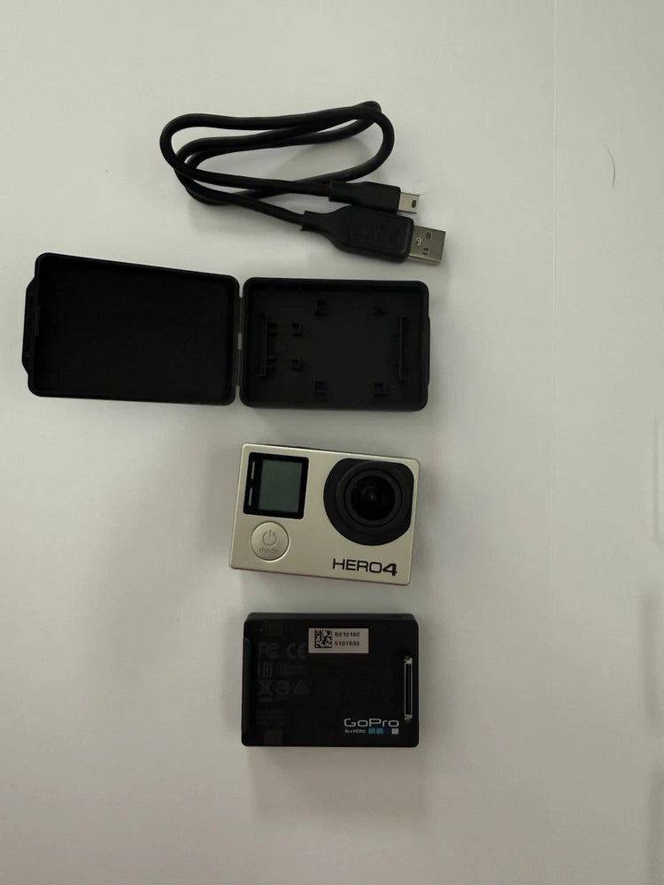 Silver GoPro HERO4 action camera with USB cable, black case and battery door