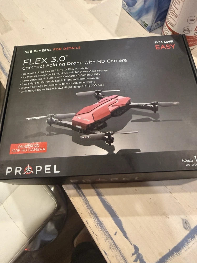 Red and black folding quadcopter drone with HD camera