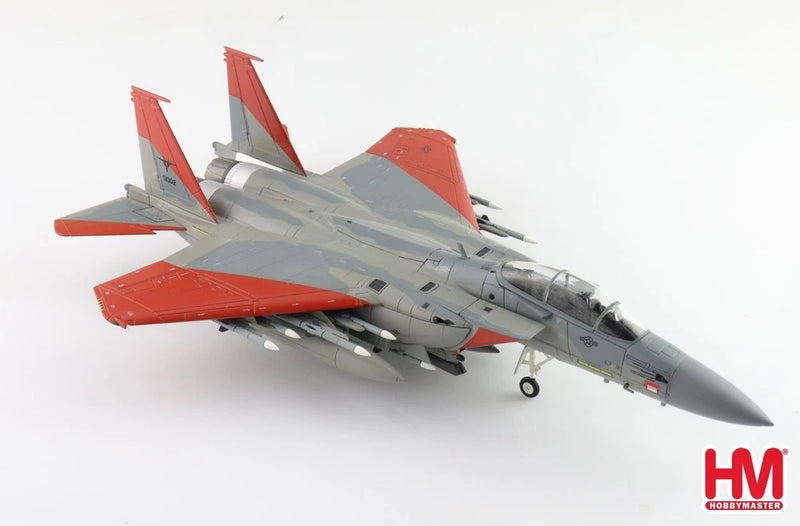 Gray F-15SA fighter jet model with red tail and wings, landing gear down