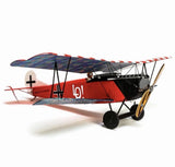 RC biplane scale model with red-and-blue camouflage fuselage, black struts, landing gear