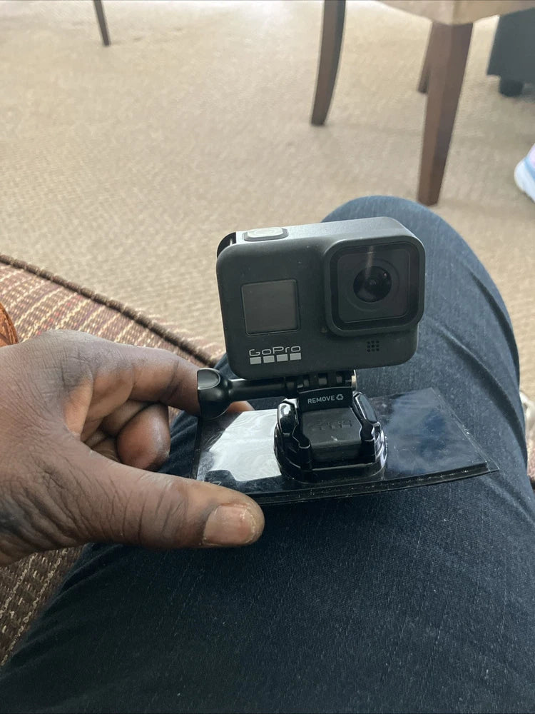 GoPro HERO8 Black action camera with mount, shown in hand.