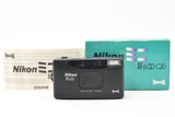 Black Nikon AF600 QD 35mm point-and-shoot film camera with teal Panorama box