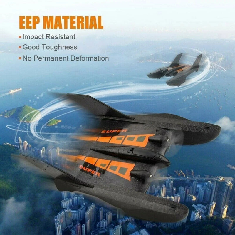 UFO-shaped RC glider drone aircraft, black body with orange and yellow panel decals