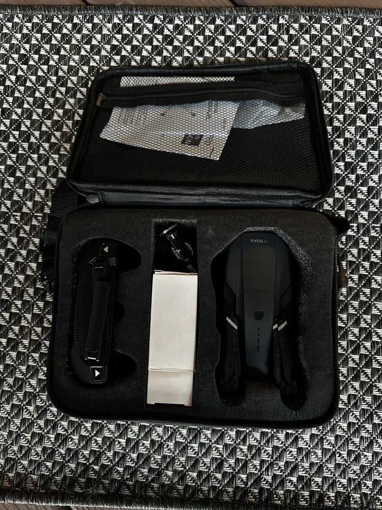 FPV racing drone kit in open black carrying case with compartments and accessories