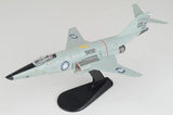Light gray and black jet model aircraft on display stand with tail markings