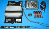 Silver Fujifilm digital camera with wrist strap, protective case, and batteries