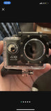 4K Ultra HD action camera in clear housing, front lens and circular controls